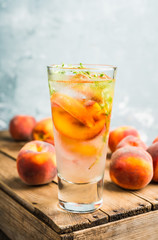 Gin based cocktail with peaches and thyme. Selective focus. Shallow depth of field.