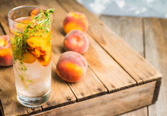 Gin based cocktail with peaches and thyme. Selective focus. Shallow depth of field.