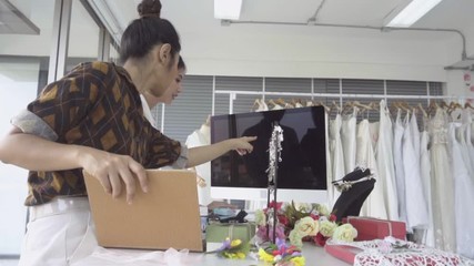Future bride customer talking with wedding store shopkeeper to buy wedding dress and accessories for her upcoming wedding ceremony.