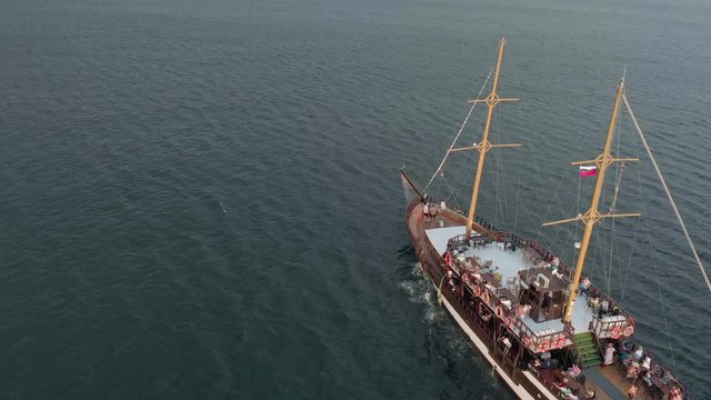 High-altitude two-masted high-altitude vessel near the coast of the sea. Aerial shot
