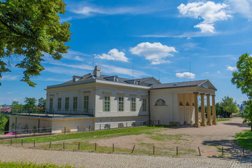 Ancient building with columns in the park in sunny weather