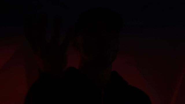 Rapper guy rap in front of the camera on a colorful background