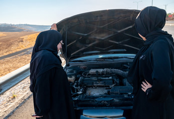 Arabic women car having problem in the street