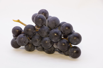 Fototapeta premium branch of black grapes on white background