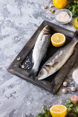 Fresh branzino fish with parsley, lemon and pink Himalayan salt