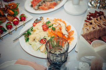 Catering. Off-site food. Banquet table with portioned salads with salmon.