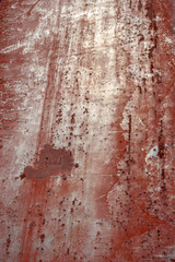 Abstract grunge background. Old rusty metal. Red colors. Scratches and chips. Glare.