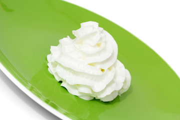 Whipped cream on green plate