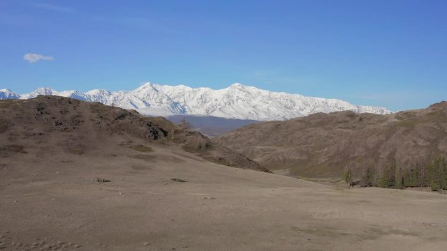 Mountain peaks, blue sky, bird, envirement. Shooting with drone 4K.