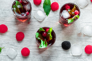 Red stemware shot alcoholic cold cocktail with cranberries raspberries and mint. copy space, top view.