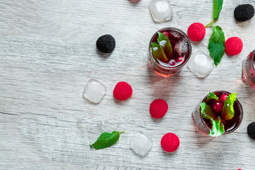 Red stemware shot alcoholic cold cocktail with cranberries raspberries and mint. copy space, top view.