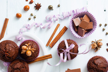 chocolate muffins with hazelnuts on white wooden