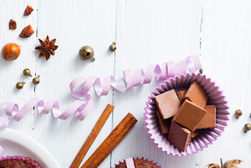 chocolate muffins with hazelnuts on white wooden