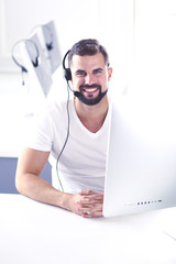 Businessman in the office on the phone with headset, Skype