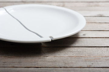 broken porcelain plate on old wood table