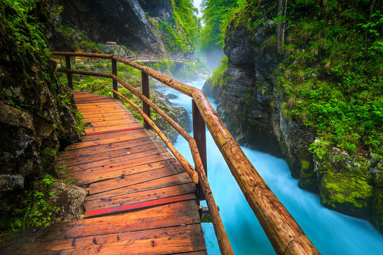 Noisy Radovna river in Vintgar gorge with wooden footbridge, Slovenia