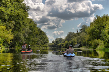 Ukraine, Psyol, 26,07,2019. Couple kayaking together in mangrove river.  Tourists kayakers touring the river of Islamorada. Ukraine, Psyol, 26,07,2019.