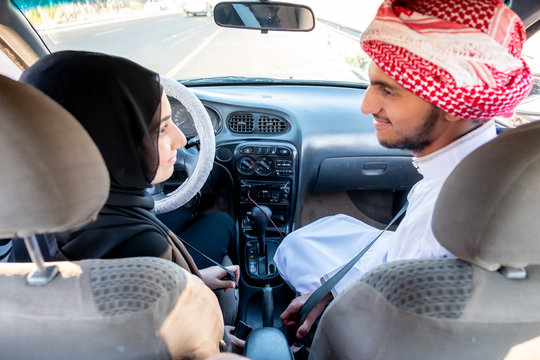 Arabic man teaching arabic woman driving