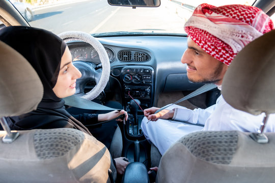 Arabic man teaching arabic woman driving