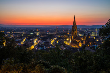 Fototapeta na wymiar Germany, Extreme red sky over city freiburg im breisgau in black forest nature landscape of baden famour for its muenster cathedral after sunset in summer