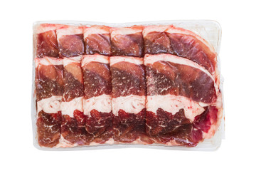 top view of frozen sliced raw beef thinly isolated on white background