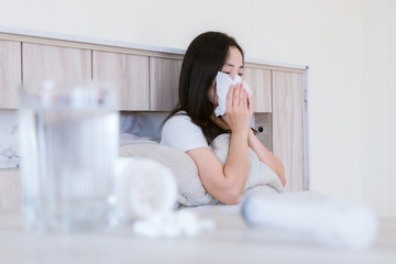 Flu medicine woman Infected With Cold the drug is placed on the table and a glass of water.