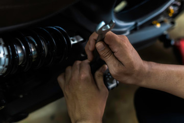 Close up, Repairing a motorcycle Use a wrench to work. Use the wrench to tighten the cylinder. Concept service in garage.