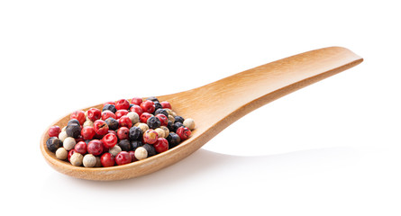 Mixed of peppers hot, red, black and white pepper in wood spoon isolated on white background
