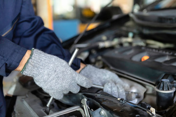 Close up, Auto mechanic People are repair a car Use a wrench and a screwdriver to work. Repair service. authentic close-up.