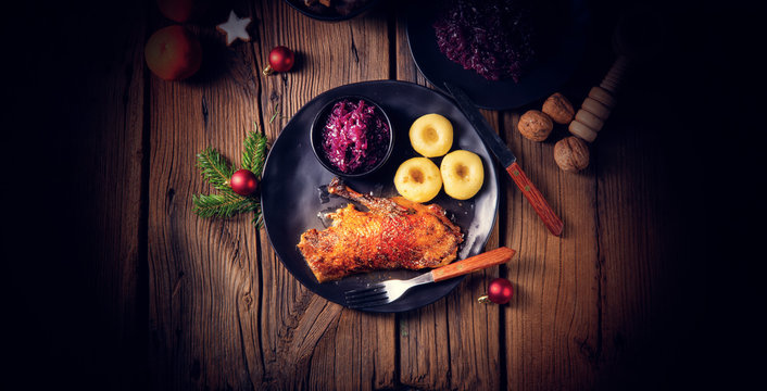 Roast goose with baked apples, red cabbage and dumplings