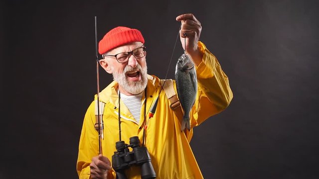 Unshaved happy overjoyed old man wth wide open mouth rejoicing at his successful cath. Hobby, interets