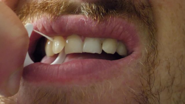 Dental hygiene, Close up of white man flossing his teeth