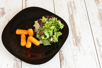 Fresh green salad with spinach,arugula,romaine, lettuce and sweet baby carrot.
