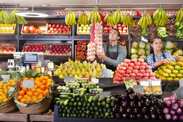 Shop assistants working in fruit and vegetable shop