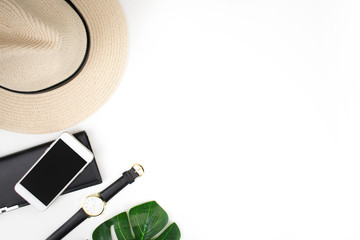 Accessories for travelers on a white background Complete with watches, smartphones, wallets, straw hats, sun glasses and leaves.