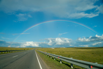 rainbow in the sky over the road