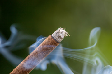 Incense stick burning with smoke, closeup . Island Bali, Ubud, Indonesia