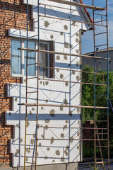 Scaffold on house, renovation. House for renovation with the scaffolding for workers on building