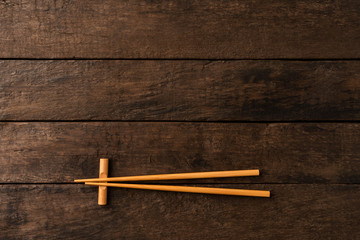 Bamboo chopstick on wooden table. Top view