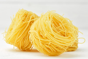 raw pasta capellini isolated on white background