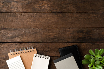 Business background in retro style with notebooks on wooden table. Office desktop