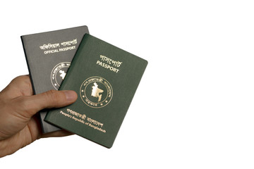 Isolated image of a hand holding several passports of the Republic of Bangladesh.