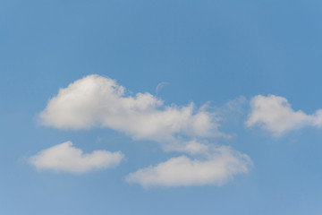 Moon in clouds by day