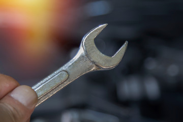 hand with car workshop tool