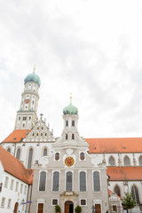 Fototapeta na wymiar Facade of the St. Ulrich and St. Afra's Abbey in Augsburg, Bavaria, Germany. Long history monastery and Basilica. It has the two sites, one for Catholic and one for Protestant churches.