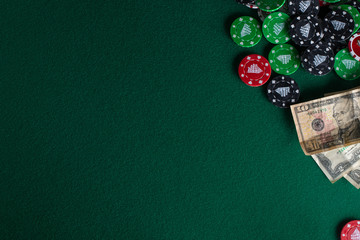 Flat lay Casino, night life, online gambling business games. Chips, cards and dollars on a green table with space.