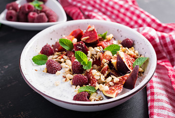 Chia seed pudding made with raspberries,  figs and mint on dark background.  The concept of good nutrition.