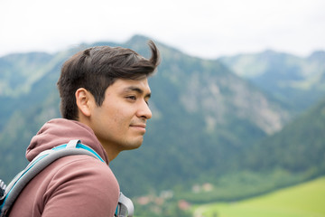 Obraz premium Man closeup portrait while on top of a mountain with high winds