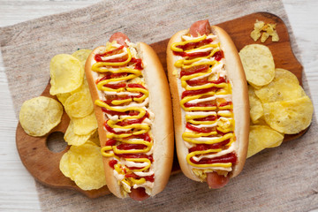 Homemade colombian hot dogs with pineapple sauce, yellow mustard and mayo ketchup on a rustic...