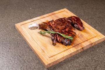 food, delicious and craft concept - cutting horse meat steak on wooden desk